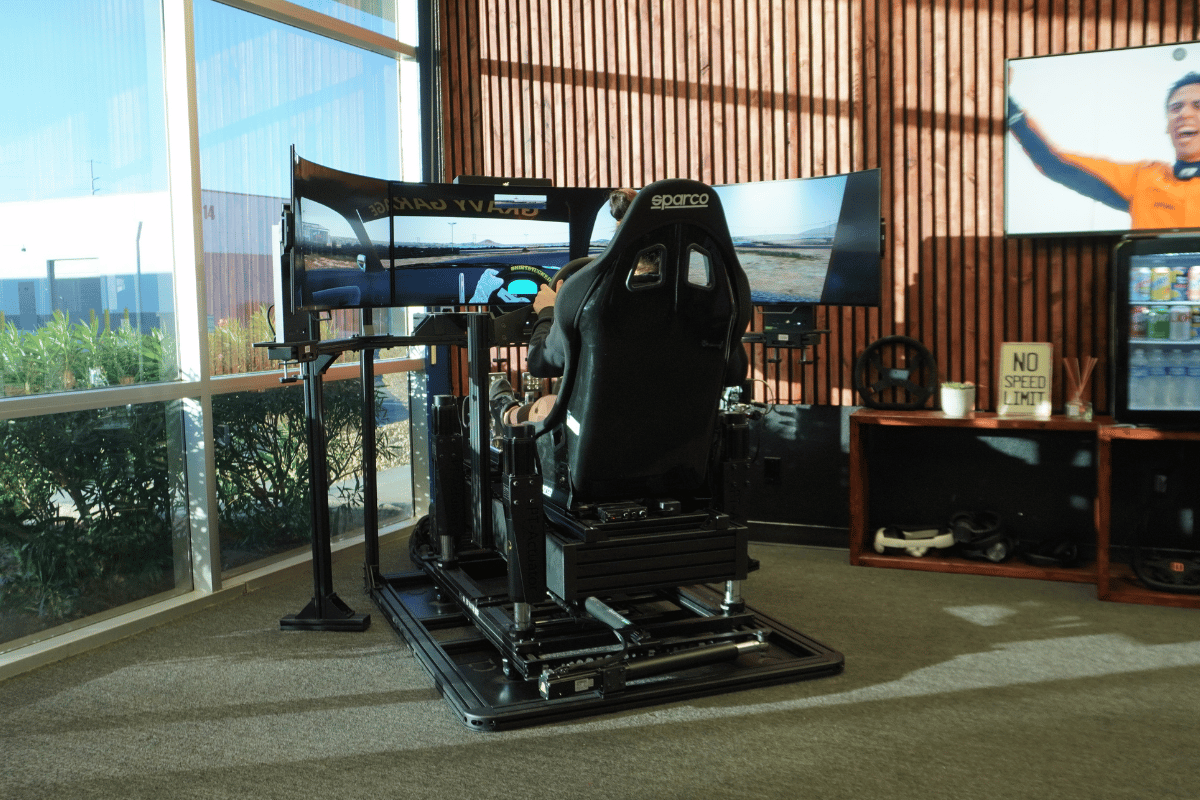 Elite 6DOF motion racing simulator with advanced hydraulic platform showing pitch roll heave surge and traction loss capabilities