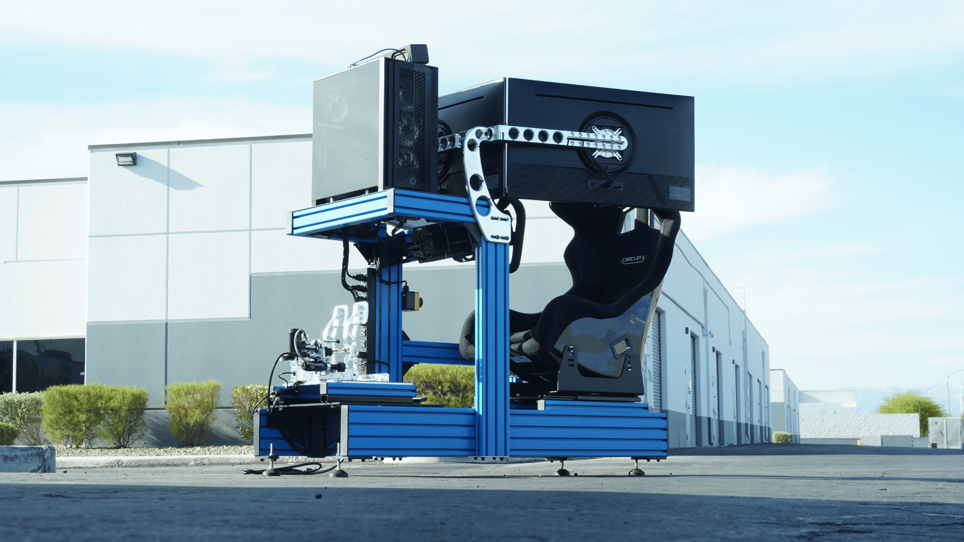 Pro static racing simulator with blue hydraulic pedals and professional steering wheel in turnkey configuration