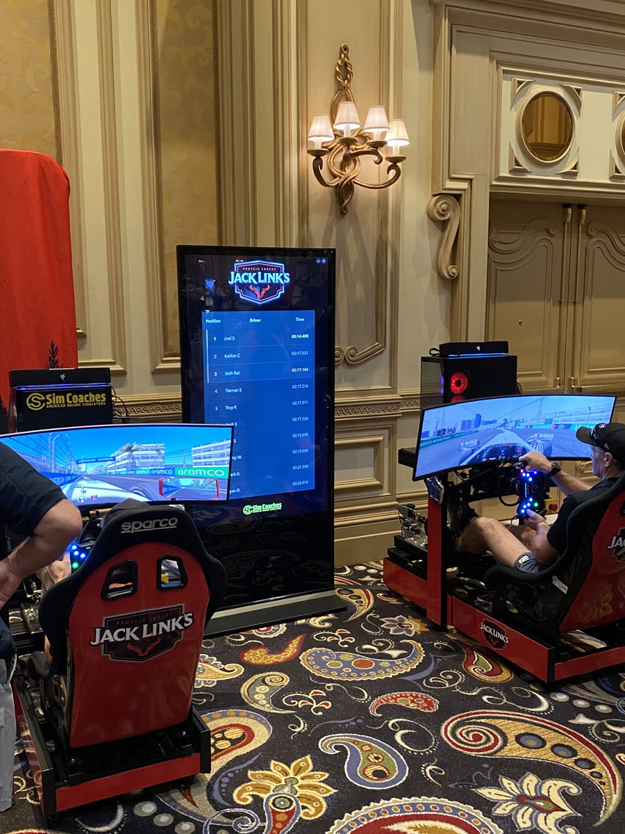 Two Jack Link's branded Sim Coaches racing simulators with live leaderboard at a Las Vegas event
