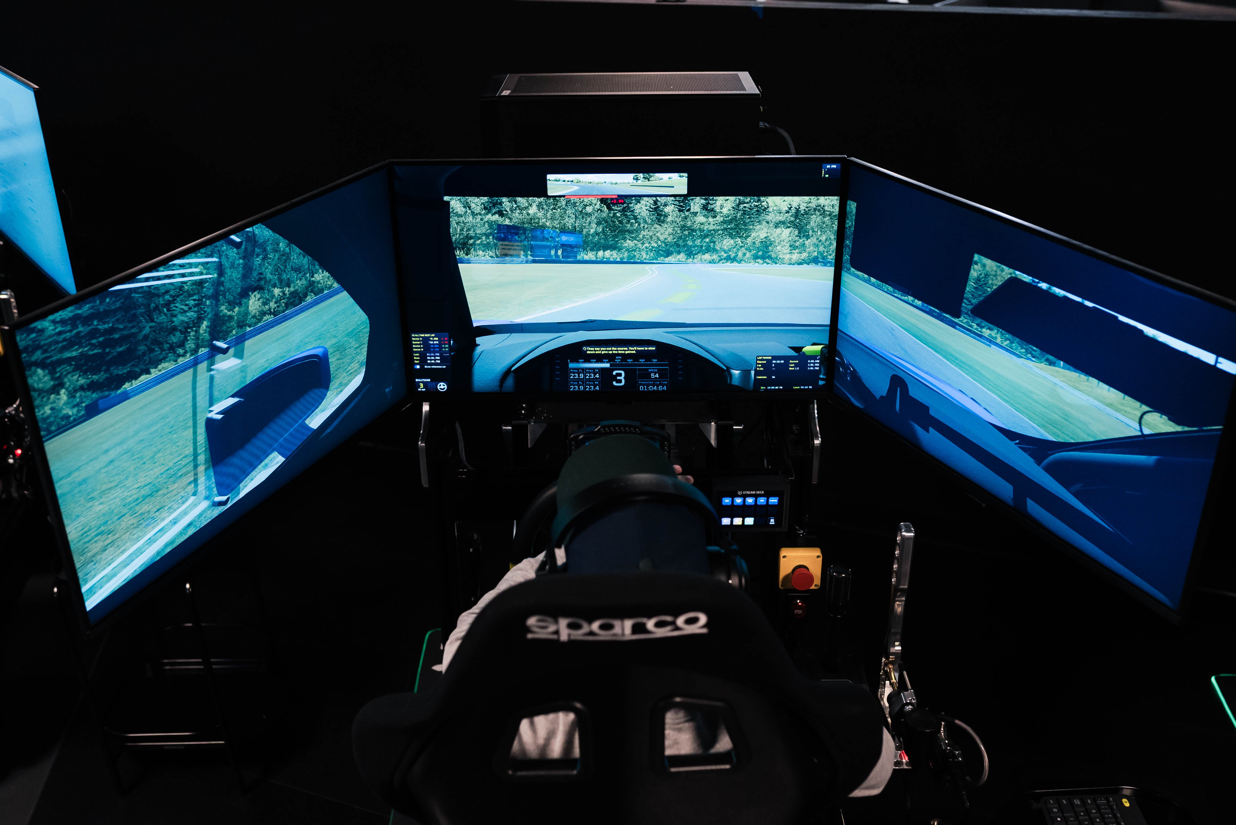 Triple 32 inch display setup with digital dash telemetry on Omega simulator