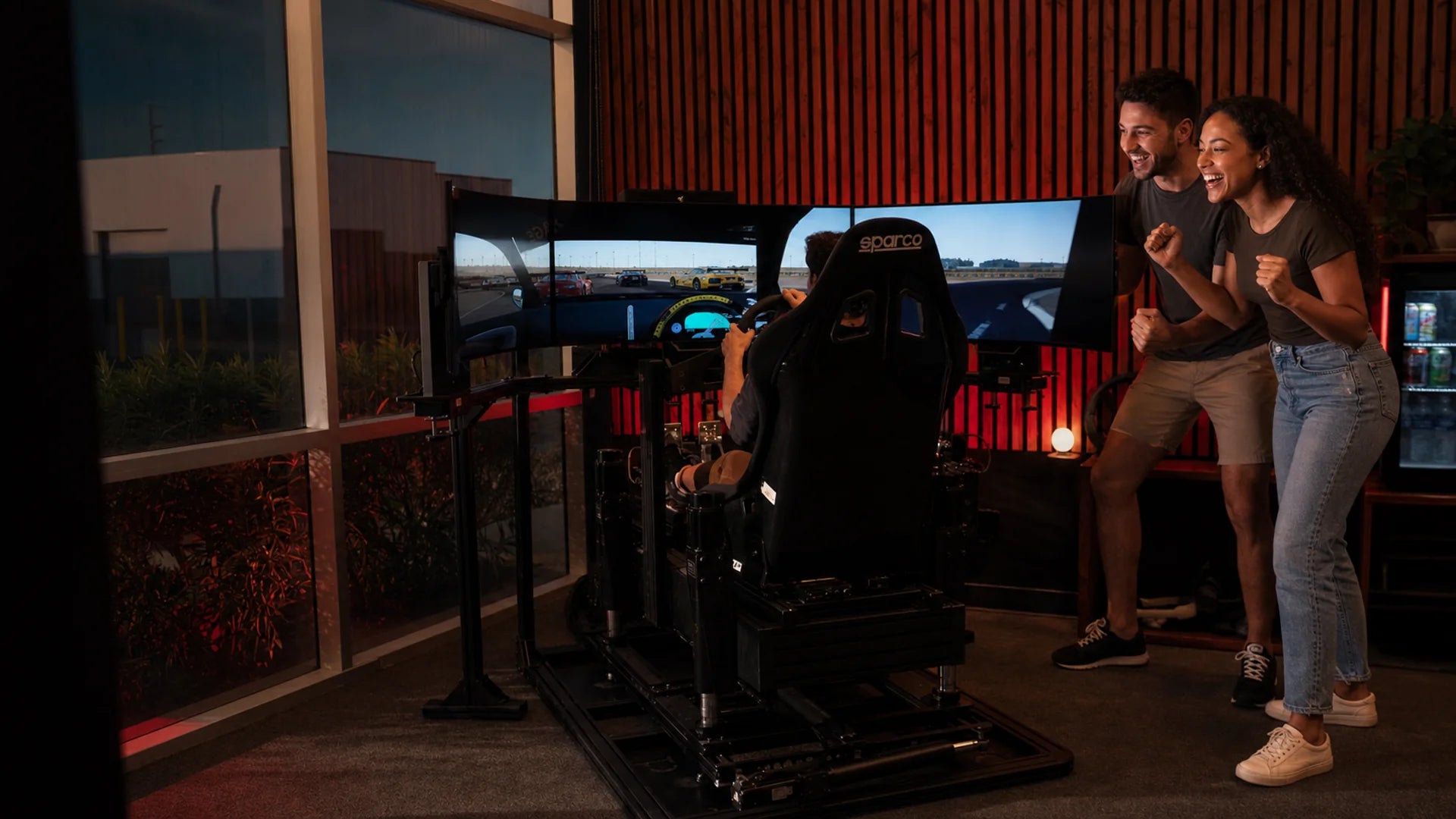 Driver racing a professional Sim Coaches simulator at The Grid Motorsport Club, Las Vegas
